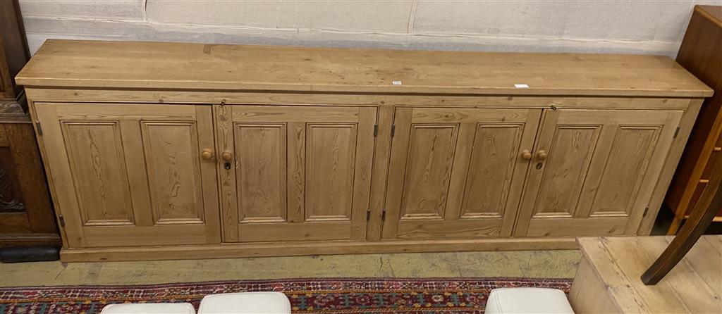 A low pine four door side cabinet, width 265cm, depth 36cm, height 83cm